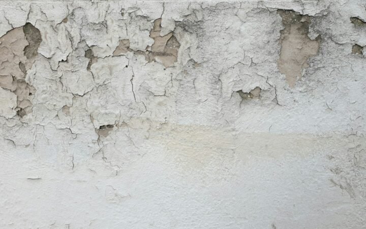 Damp wall with peeling paint after a water leak